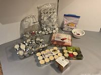 Entire assortment of packaged and loose tea-light candles on tabletop