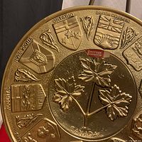 Close-up left side showing Alberta and Saskatchewan crests, Peerage label, maple leaves