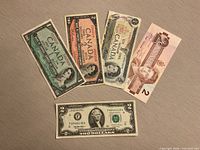 Group shot of all five banknotes fan-arranged