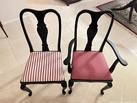 Two chairs side-by-side, one side chair with striped seat, one armchair with red seat, showing upholstery patterns and black lacquer frames