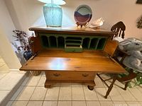 Chest open showing drop-front desk, interior cubbies