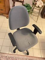 Front view of gray fabric office chair showing seat, back, armrests and casters