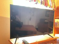 Front view of Hisense 32-inch TV on stand