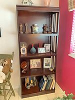 Full front view of tall dark espresso mission style bookcase with five shelves