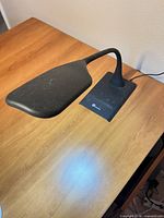 Lamp on desk, top view showing lamp head and base