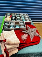 Lot overview showing ornaments in trays, stockings, wire decorations and gnome