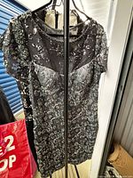 Front view gray/silver sequin dress on hanger
