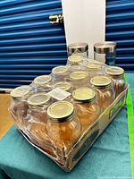 Shrink-wrapped tray of 12 Golden Harvest jars with gold lids