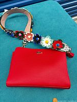 Front view showing bag front texture, logo, entire floral strap