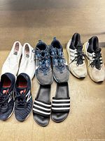 Group shot of all five pairs of men’s shoes laid out on floor
