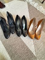 Three pairs of heels side by side showing color and style