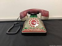 Front left view showing handset, stained-glass panels, dial and cord