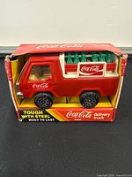Front view of boxed Buddy L Coca-Cola delivery truck showing crate and bottles