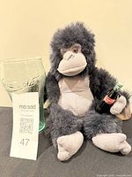 Plush gorilla, Coca-Cola glass and mini bottle group shot