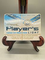 Front view of sealed Player's Light cigarette tin