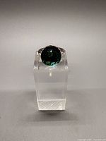 Front view showing iridescent crystal and mount