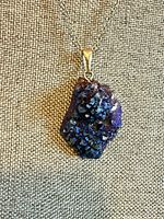 Close-up of druzy pendant on chain