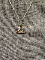 Necklace close-up showing pendant detail and chain