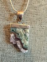 Front view of pendant showing stone colors and druzy edge