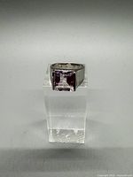 Front view showing square purple stone set in sterling silver band
