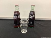 Front view of both sealed bottles and tumbler