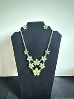 Necklace displayed on bust with matching earrings