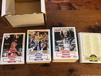 Open box with stacked 1990 Fleer cards; visible Jordan, Johnson, Robinson, checklist.