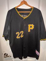 Front view of black Pirates jersey with number 22 and gold P logo