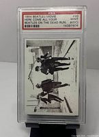Front of PSA-slabbed 1964 Beatles Movie card #50 showing Beatles running image and PSA label with grade 9(OC)
