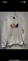 Front view of white crew-neck sweatshirt with McDonald’s characters graphic