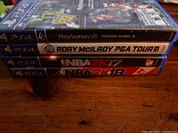 Stacked view of four PS4 game cases showing spines