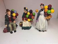 Front view of all three Royal Doulton balloon figurines