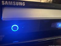 Front left corner showing Samsung branding and blue power button