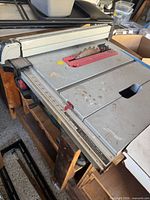 Top view of Bosch table saw, blade, rip fence, surface wear
