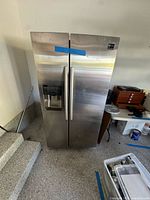Full front view of stainless steel Samsung side-by-side refrigerator