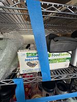 Sealwrap film roll box and FoodSaver bags package on shelf