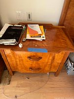 Top view of first nightstand showing wood grain, two drawers, integrated pulls