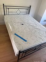 Top view of bed showing mattress on black metal frame