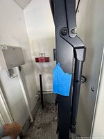 Close-up of hinged section with blue tape on black metal frame