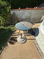 Round patio table and umbrella stand from above