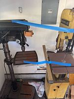 Powermatic band saw and drill press side by side