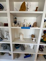 Shelf with multiple 3D-printed figures on left, centre and right