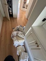 Pile of assorted folded and loose linens on floor