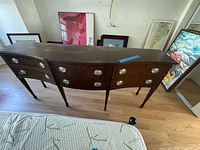 Front view showing overall design, drawers, pulls and legs