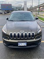 Front view of 2015 Jeep Cherokee showing grille, headlights and licence plate