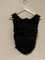 Front view of black Lululemon backpack hanging on hanger