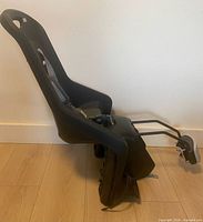 Side view of Polisport child bike seat showing mounting bar and clamp