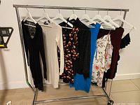 Rack with eight assorted dresses on hangers