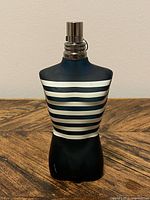 Front view of torso-shaped bottle with stripes