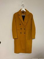 Full front view of mustard yellow Topshop coat on hanger